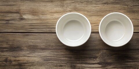Aufkleber - Kitchenware and dishware idea. A top view of two new white ceramic bowls placed on a wooden table with a background featuring copy space.