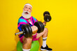 © deagreez - Photo portrait banner of funny senior sportsman lifting weights dressed stylish retro sport costume isolated on yellow color background