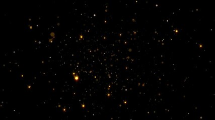 abstract background with glittering gold dust particles on a black background.