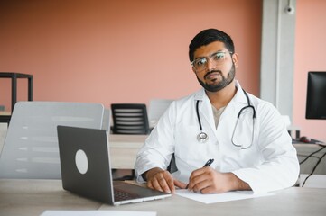 Portrait of happy friendly male Indian latin doctor medical worker wearing white coat with stethoscope. Medical healthcare concept