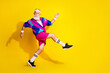 © deagreez - Full length photo of attractive funny retired sportsman retro sportswear enjyoing jogging emtpy space isolated yellow color background