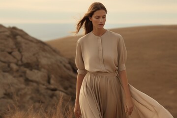 Wall Mural - woman standing wearing a minimal dress nature outdoors fashion.