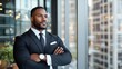 © Pinklife - A confident man in a suit stands by an office window, exuding professionalism and determination. His thoughtful gaze suggests strategic thinking and leadership qualities.