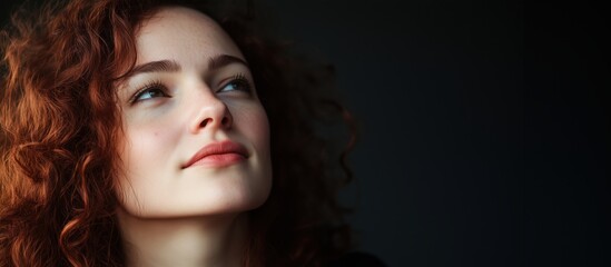 Canvas Print - Portrait of young woman with curly red hair, thoughtful expression, soft lighting