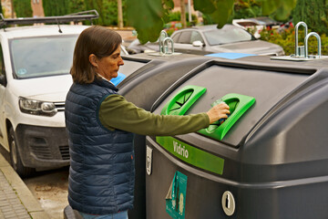 woman recycling glass bottles in urban area