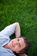 © STEEXBuyout/peopleimages.com - Woman, portrait and happy on grass space for relax, peace and positive mental health. Calm, mature person and smile in nature park for summer comfort, freedom and stressless environment for wellness