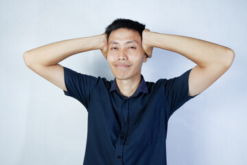 Asian man holding his head with both hands. white background