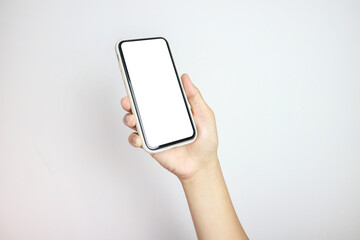 Close up of young man hand holding modern smart phone mockup. New modern black frameless smartphone mockup with blank white screen. Isolated on white background high quality studio shot Modern smart