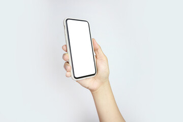 Close up of young man hand holding modern smart phone mockup. New modern black frameless smartphone mockup with blank white screen. Isolated on white background high quality studio shot Modern smart