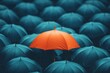 © pattaporn - Vibrant Orange Umbrella Among Blue Umbrellas in Rain