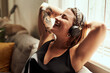 © Malambo/peopleimages.com - Relax, smile and woman with headphones, lounge and chilling with music, streaming and comfortable. Home, sound and calm with radio, sleeping and person in living room, podcast and rest in apartment