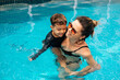 © kleberpicui - Happy Brazilian boy with his mother having fun in the swimming pool