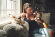 © Malambo/peopleimages.com - Woman, coffee and dog on home couch in morning with relax, calm and break with pet and care. Love, smile and tea with animal, chihuahua and person together on the weekend with bonding and comfortable