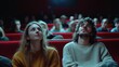 © Charoen - A man and a woman are sitting in a movie theater, looking at the screen