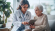 © Shinonome Studio - Female doctor, wearing a shiny white coat is using an iPad to assist a patient.