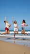© Pixel Matrix - Friends jumping happily on the sandy beach Multicultural Group Playful Fun