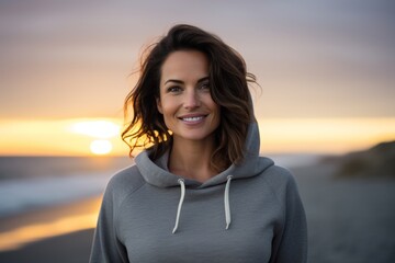 Sticker - Portrait of a glad woman in her 30s dressed in a comfy fleece pullover isolated in stunning sunset beach background