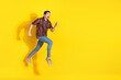 © deagreez - Full length portrait of nice young man jump run empty space wear shirt isolated on yellow color background