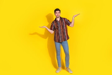 Canvas Print - Full length portrait of nice young man hold empty space wear shirt isolated on yellow color background