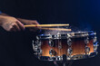 © puhimec - Drum sticks hitting snare drum with splashing water on black background.