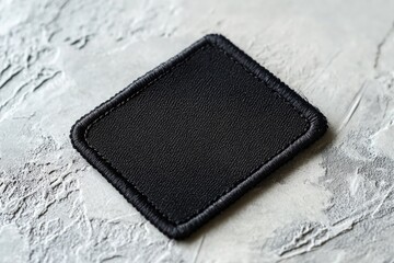 a small black patch sits atop a table, possibly a stain or a marker