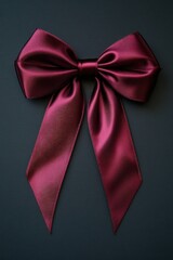 Poster - A bright red satin bow set against a black background, perfect for adding a pop of color to your design