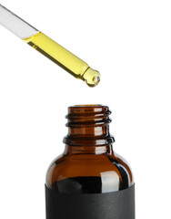 Sticker - Dripping tincture from pipette into bottle against white background