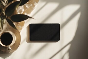 Poster - A cup of coffee placed next to a black square on a table
