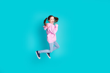 Wall Mural - Full body photo of cute little girl running jump have fun dressed stylish pink clothes isolated on aquamarine color background