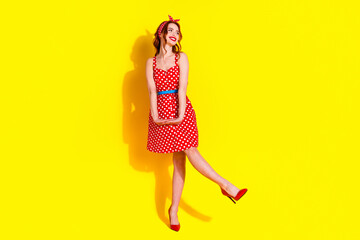 Sticker - Full length photo of cheerful glad pretty lady wear red stylish dress dance empty space isolated on vibrant yellow color background