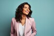 © Markus Schröder - Portrait of a smiling indian woman in her 30s wearing a professional suit jacket on pastel or soft colors background