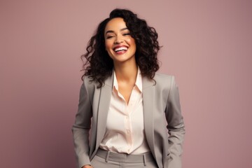 Poster - Portrait of a smiling indian woman in her 30s wearing a professional suit jacket in front of pastel or soft colors background