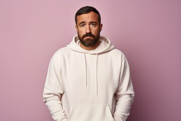 Poster - Portrait of a glad man in his 30s sporting a comfortable hoodie isolated in pastel or soft colors background