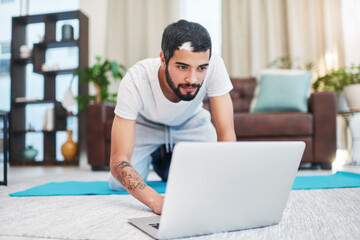 Canvas Print - Yoga, man and laptop on floor in house for online pilates routine and watching exercise video for tutorial. Workout demonstration, yogi and tech on mat for virtual class and fitness lesson in lounge