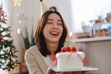 Wall Mural - Beautiful Asian woman holding a strawberry cake. Asain Woman with Happy Birthday Celebrate party.