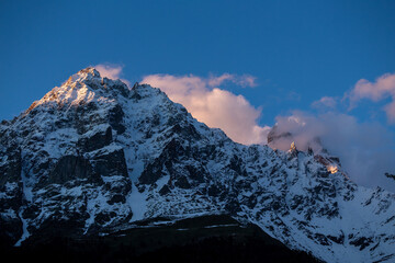 Wall Mural - Snowy mountain peak in clouds, Mount Ushba in Georgia