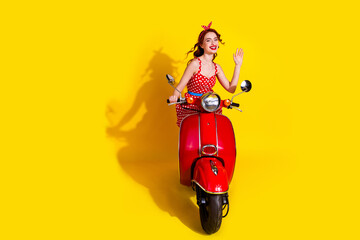 Sticker - Photo of pretty cute positive lady wear red stylish sarafan riding moped isolated on yellow color background