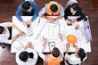 © InfiniteFlow - Top view banner of diverse group of civil engineer and client working together on architectural project, reviewing construction plan and building blueprint at meeting table. Prudent