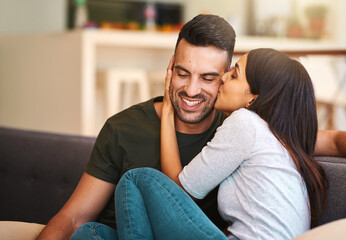 Wall Mural - Smile, couple and kiss on couch at house with love, bonding together and healthy relationship for security. Happy, people and affection with calm morning, romance and partner gratitude for commitment