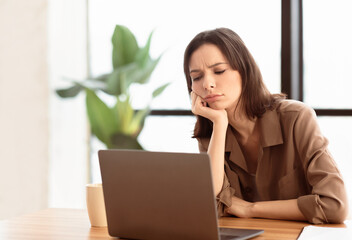 Aufkleber - Overworked Person. Bored girl using laptop sitting at table in contemporary office, free space