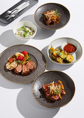 Wall Mural - Gourmet Meat Dishes Elegant Presentation with Fine Dining Aesthetic