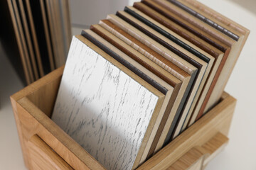 Poster - Different samples of wooden flooring on white table, closeup