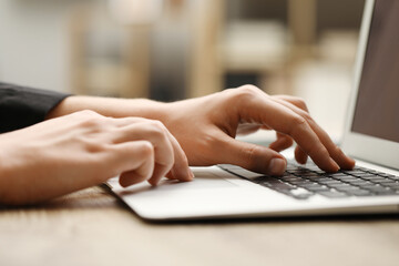 Businessman using laptop at table, closeup. Modern technology