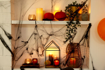 Wall Mural - Burning candles on shelves decorated for Halloween