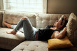 © Malambo/peopleimages.com - Woman, home and relax on sofa with sleeping on break, rest and tired with dreaming. Female person, apartment and smile on couch in living room with nap to chill and calm with peace and zen in house