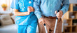 © missisya - Nurse Helping Elderly Man With Walking Stick In Hospital