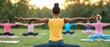 © kamon - Group yoga session in a serene outdoor setting, participants practicing poses together with focus and harmony in the natural environment.