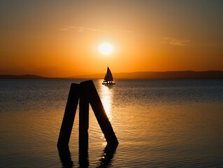 Sunset over Lake with Sailboat