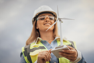 Poster - A Proud Engineer Holding a Wind Turbine Model A Strong Symbol of the Ongoing Innovation in Renewable Energy Solutions and Sustainable Practices That Benefit Our Environment and Communities
