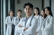 © Archibalttttt - Confident doctor leading medical team in hospital corridor
